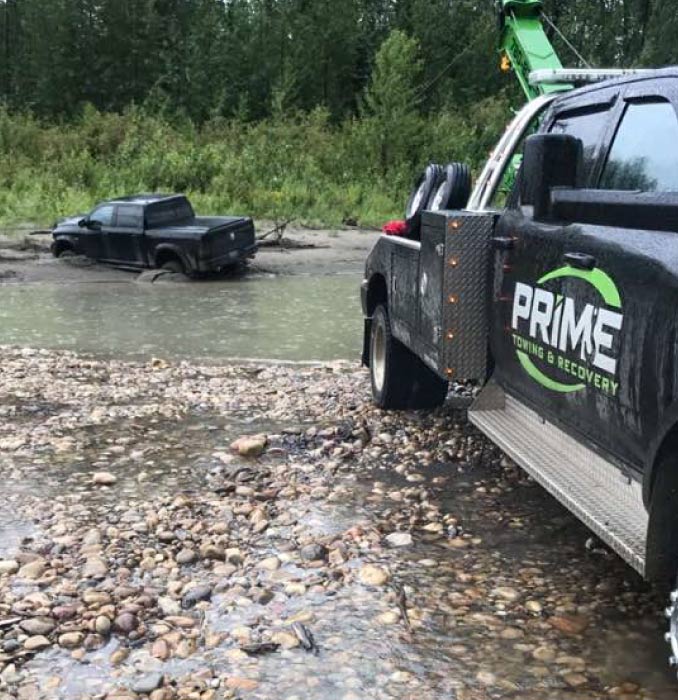 Prime Tow Truck Rescuing a Truck Out of a River Near Grande Prairie, AB